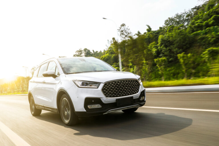 White suv speeding on fast road